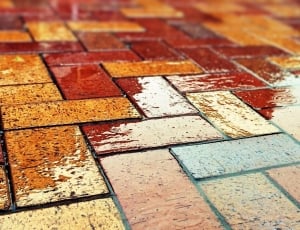 close up photo of brown, blue, and beige stone brick floor thumbnail