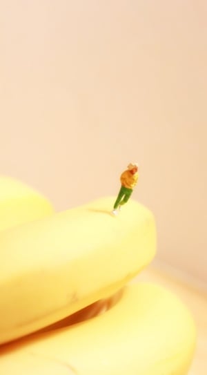man in yellow t shirt and green pants ceramic miniature figurine thumbnail