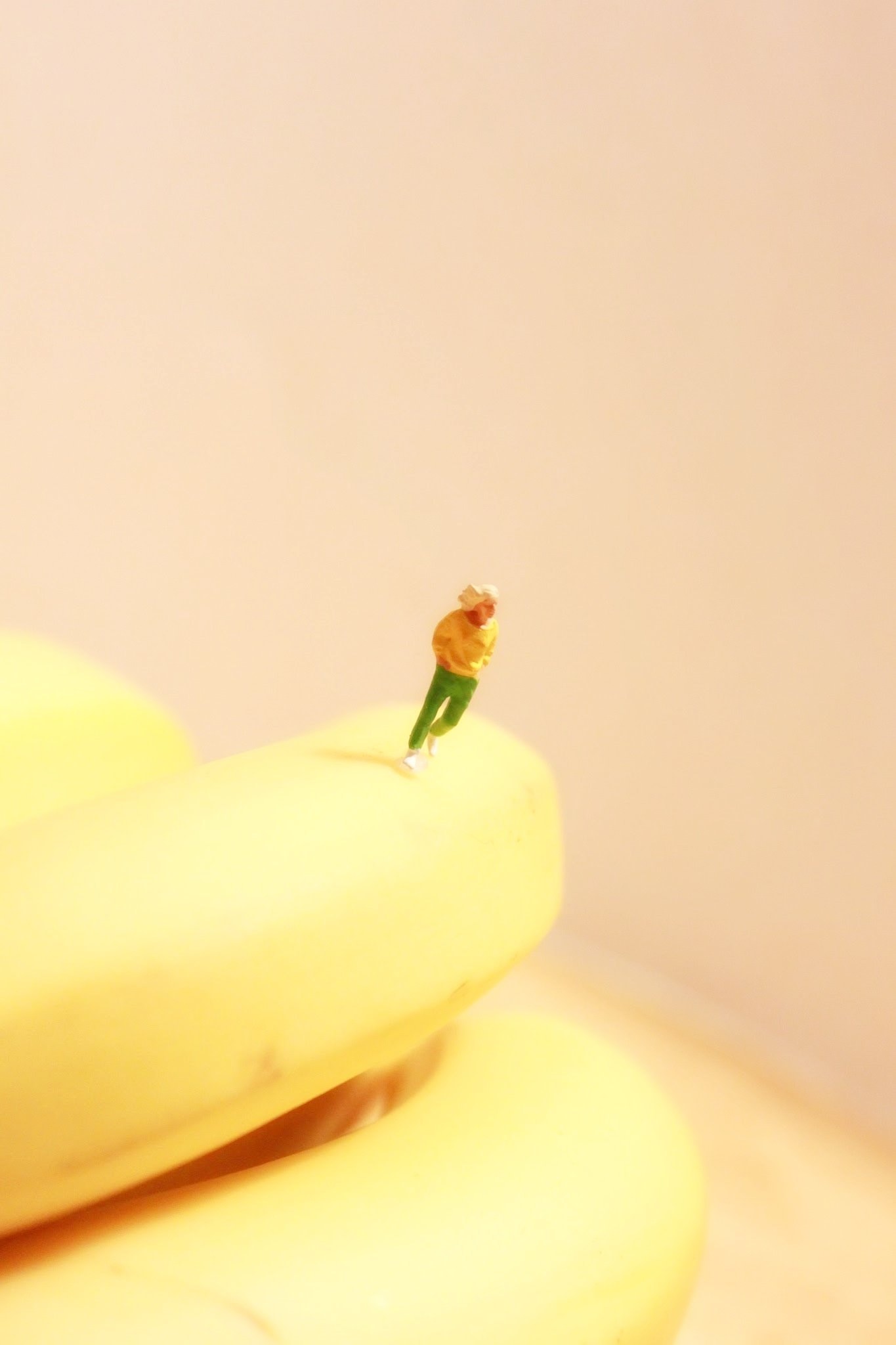 man in yellow t shirt and green pants ceramic miniature figurine