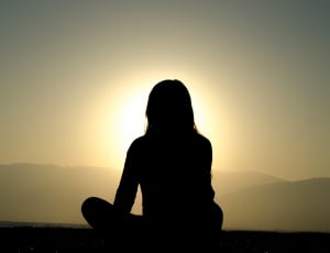silhouette of woman sitting during golden hour thumbnail