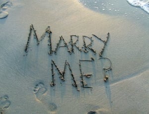 Marry me sand text on shore during daytime thumbnail