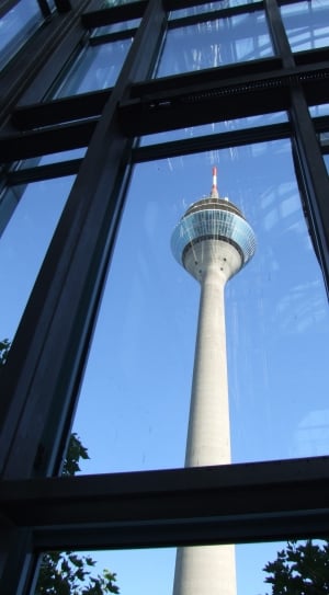 low angle view of tower and metal framed glass window thumbnail