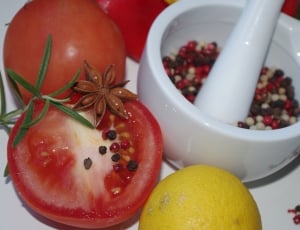 white ceramic mortar and pestle and red tomato thumbnail