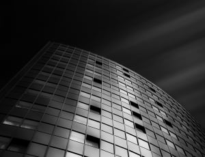 greyscale photo of glass curtain wall high rise building thumbnail