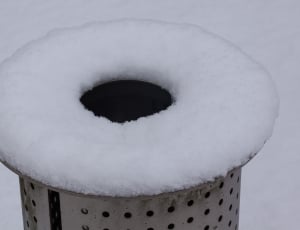 round tubular hole gray metal covered on snow thumbnail