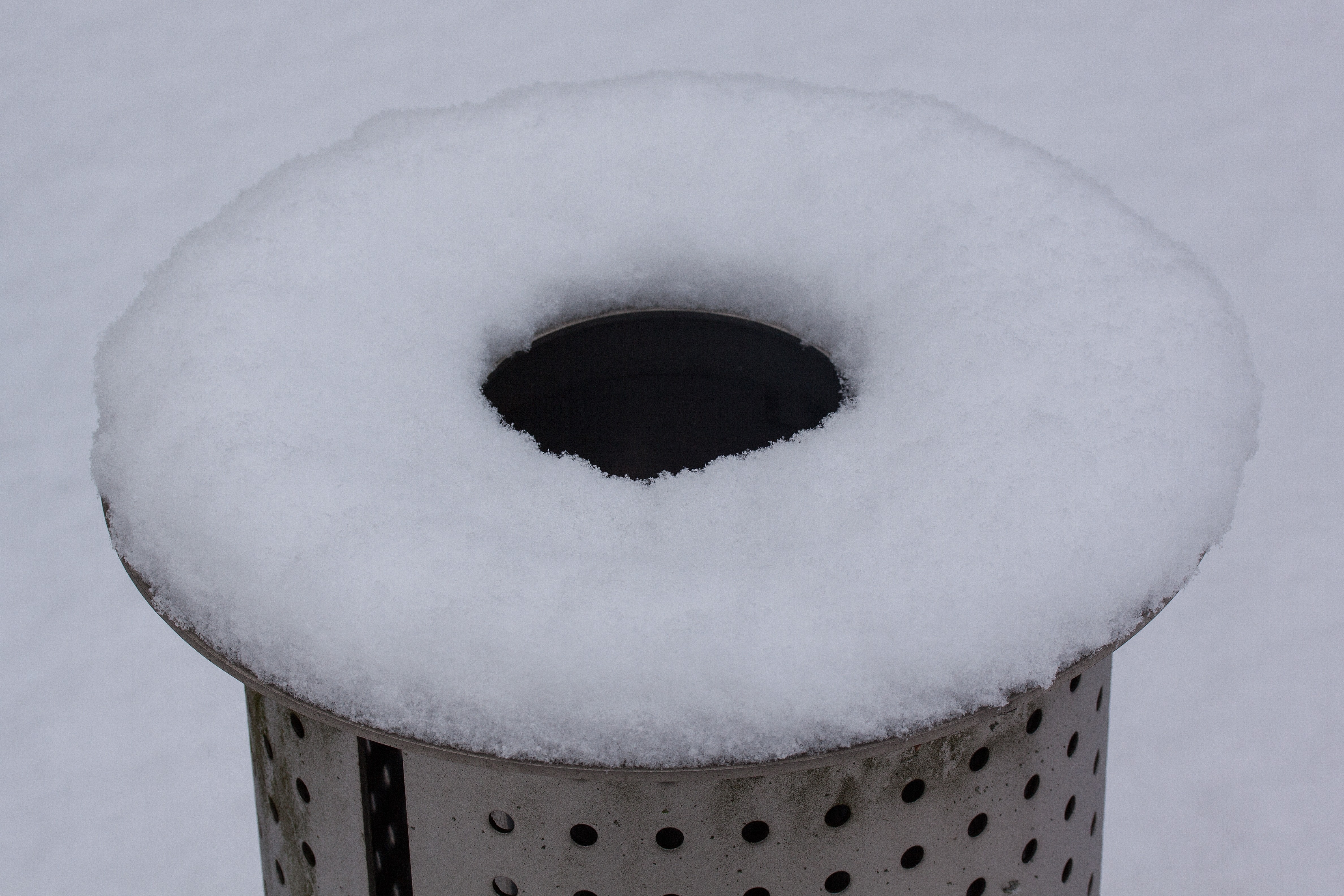 round tubular hole gray metal covered on snow