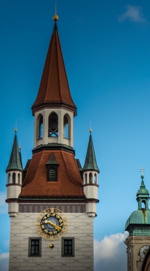 brown and green tower with clock thumbnail