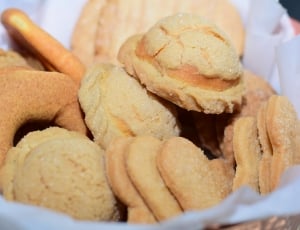 baked cookies on white linen covered basket thumbnail