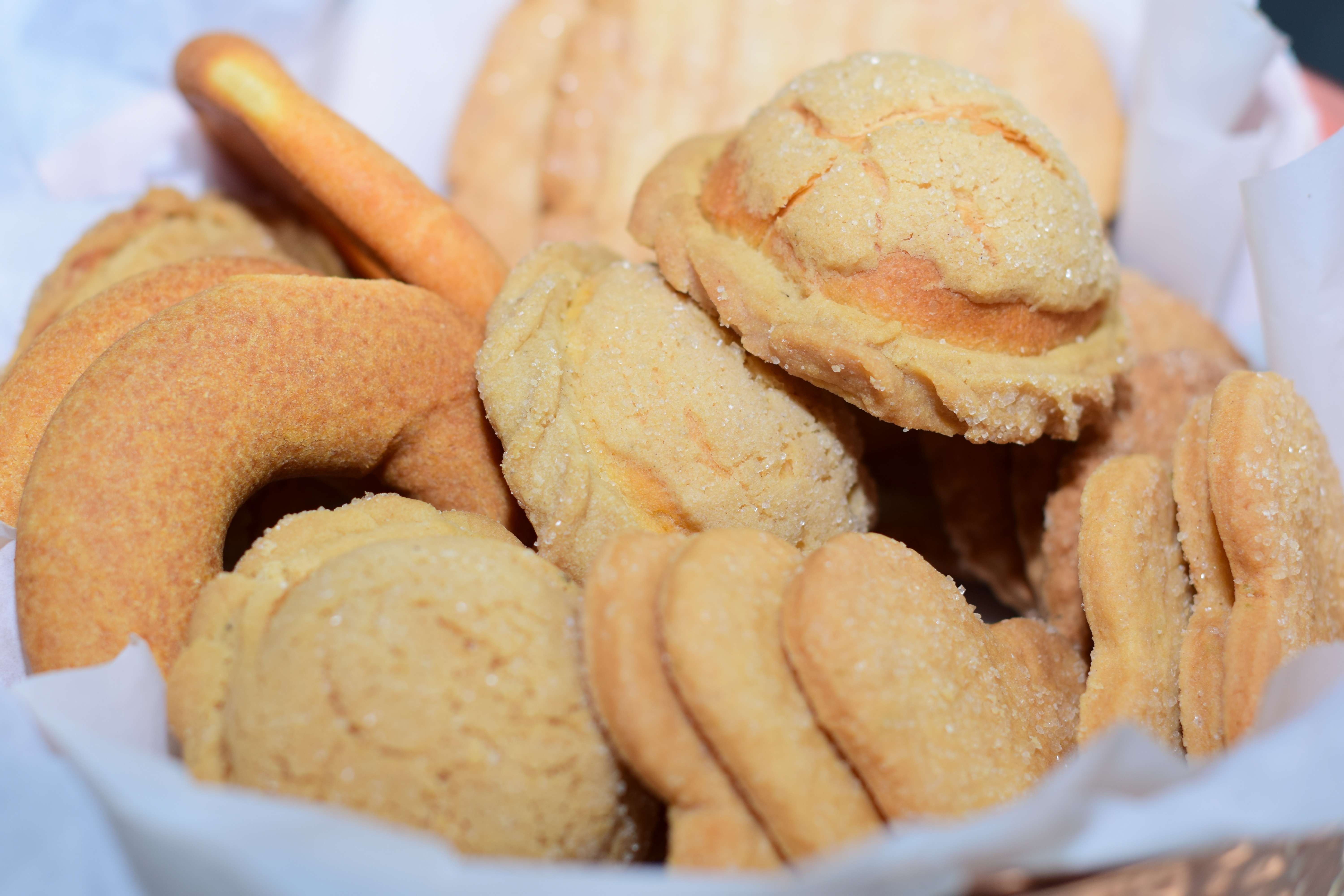 baked cookies on white linen covered basket