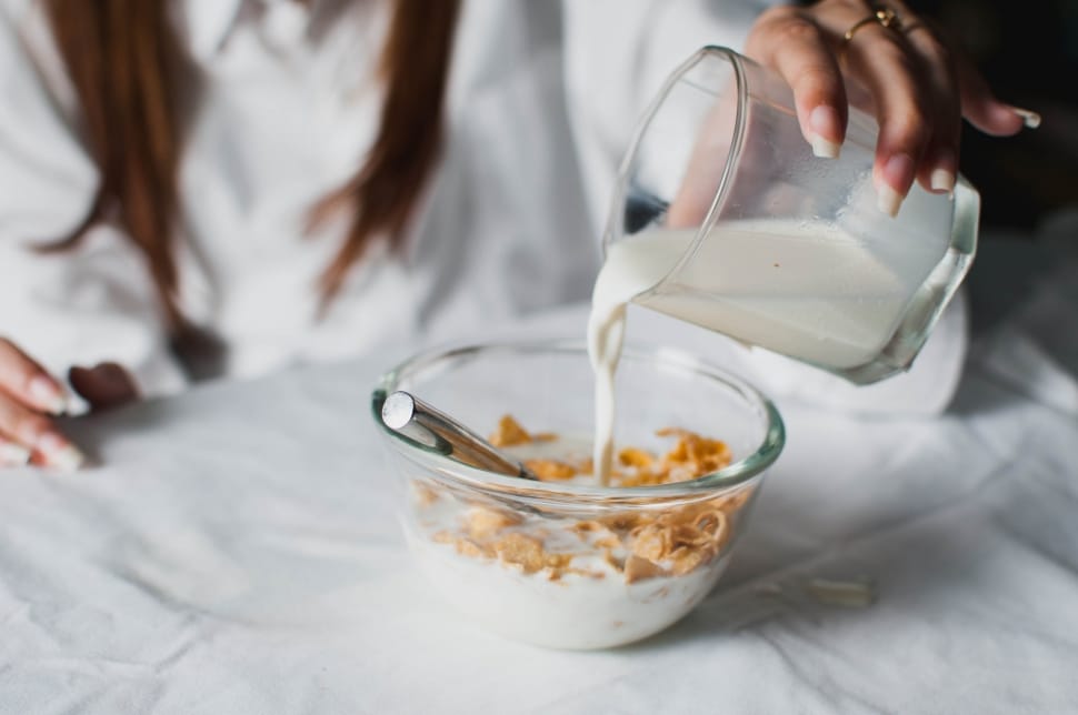 bowl of milk and cereals served on clear glass bowl preview