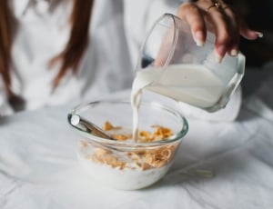 bowl of milk and cereals served on clear glass bowl thumbnail