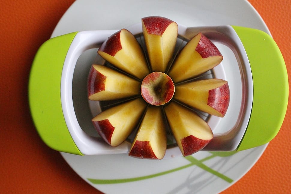 sliced apple served on green and white tray preview