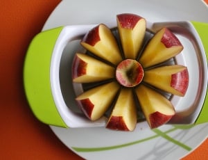 sliced apple served on green and white tray thumbnail