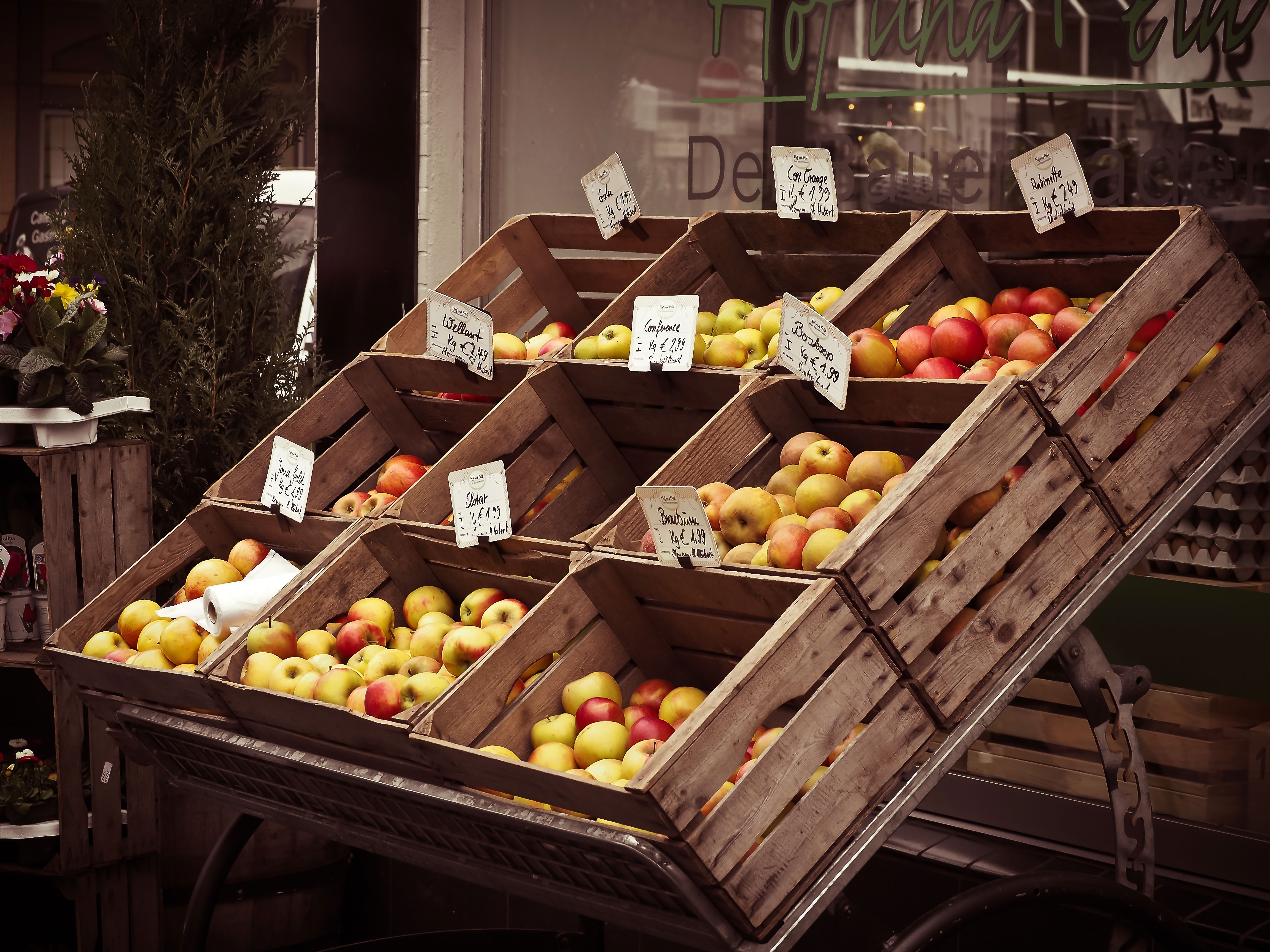 yellow and red fruits in brown wooden rack