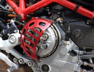 grey and red Ducati motorcycle engine closeup photography thumbnail