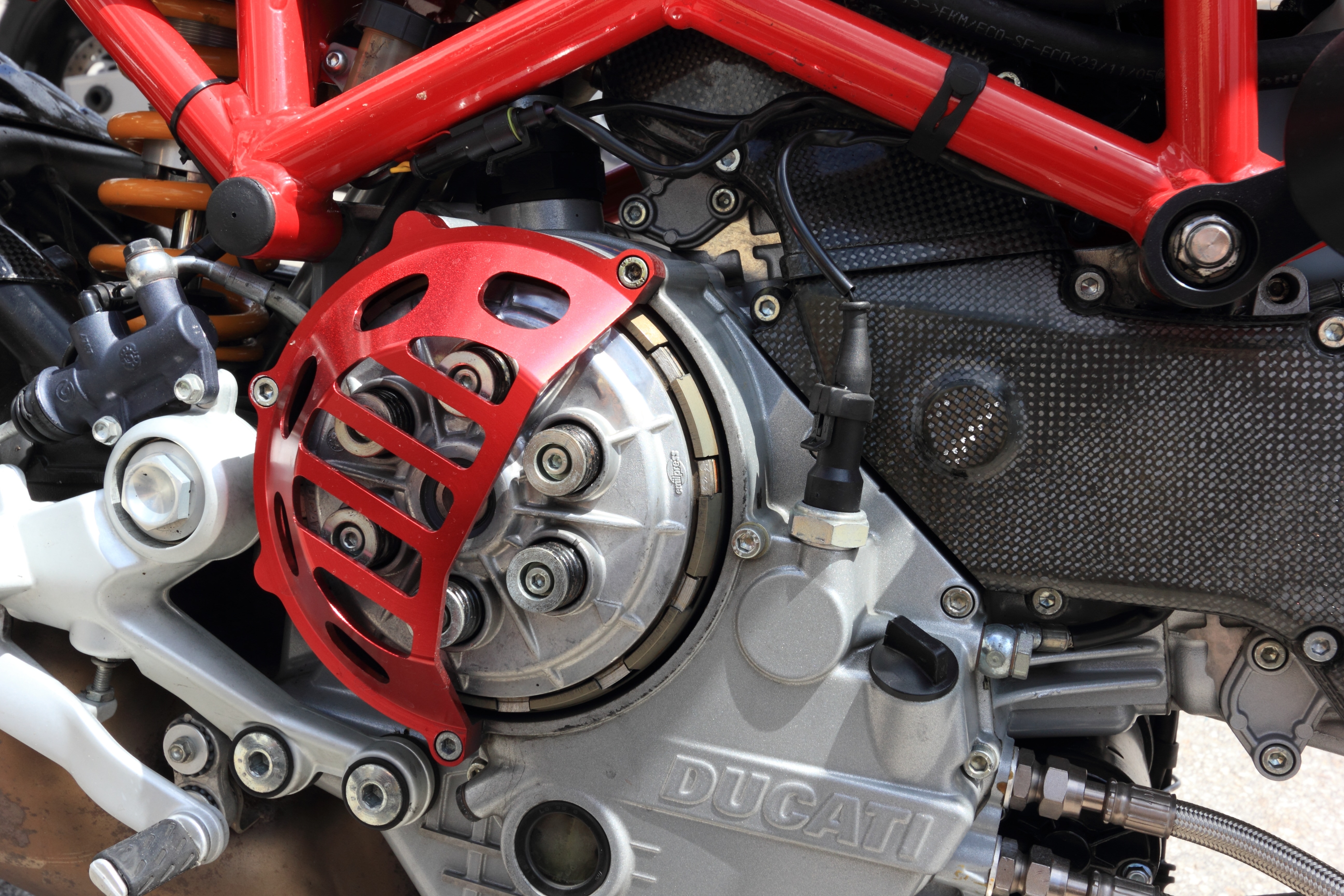grey and red Ducati motorcycle engine closeup photography