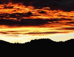 silhouette of mountains under black clouds thumbnail