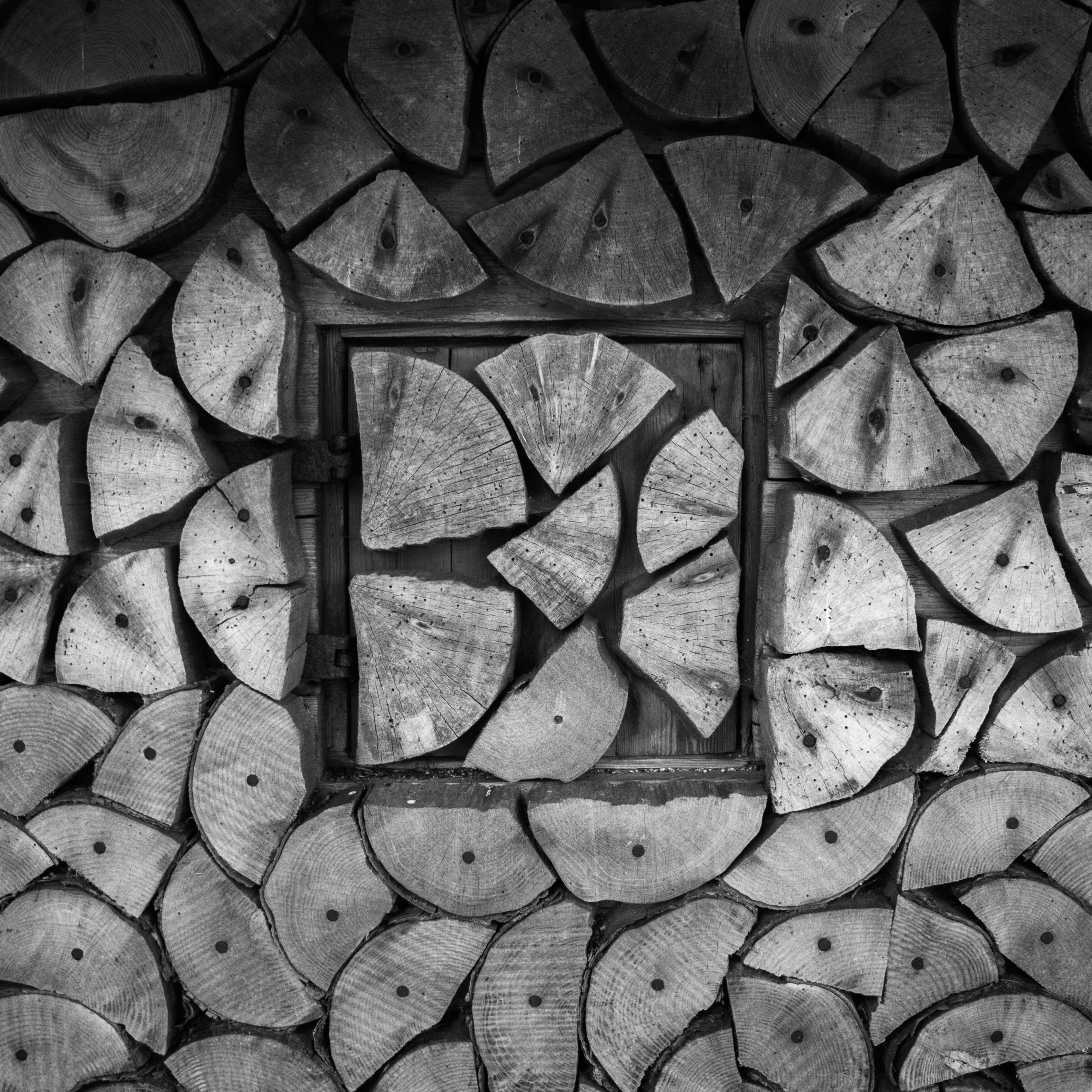 grayscale photo of firewood artwork