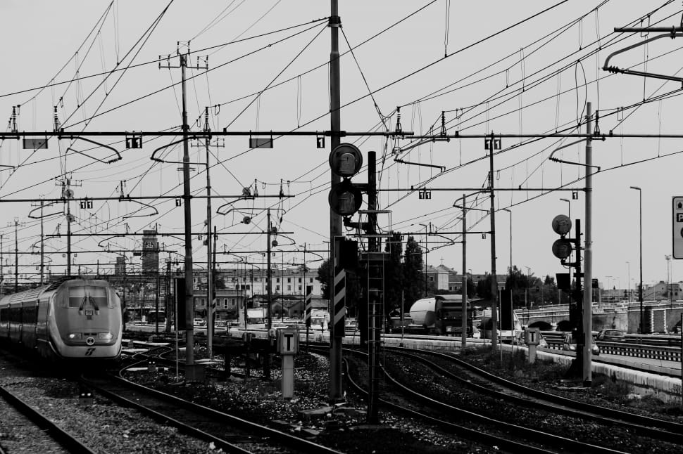 greyscale photo of bullet train and train rails preview