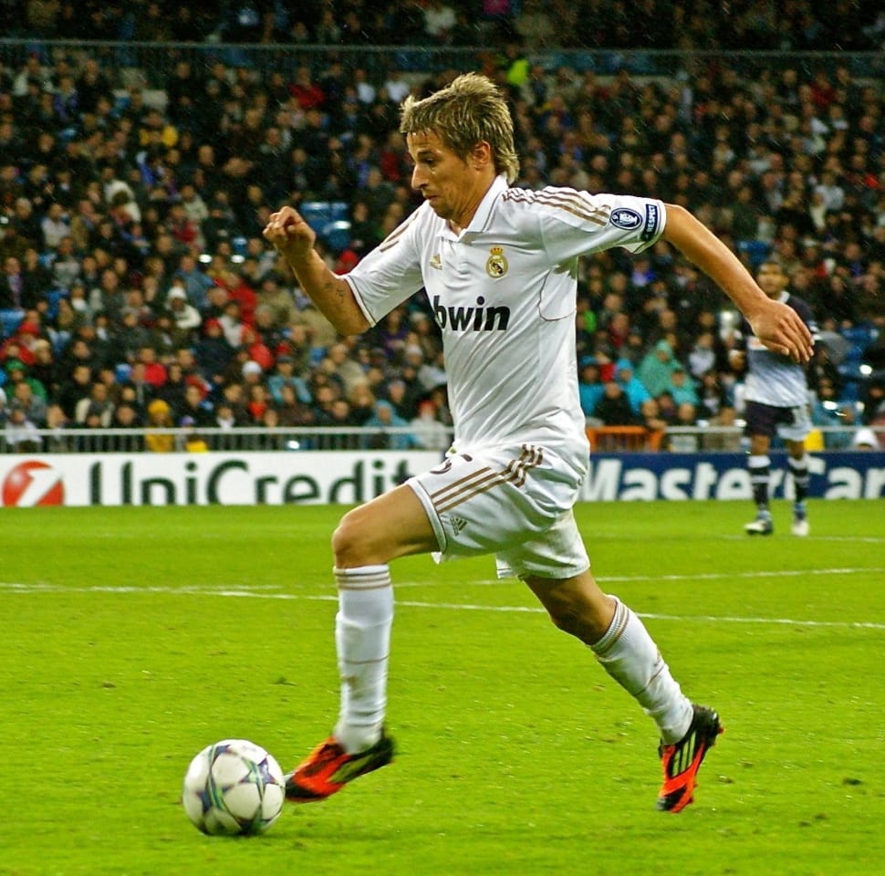 real madrid player in white jersey shirt kicking soccer ball free image - Peakpx