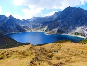 lake surrounded by mountain ranges landmark thumbnail