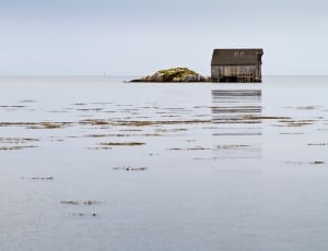 body of water with house in the middle of it thumbnail