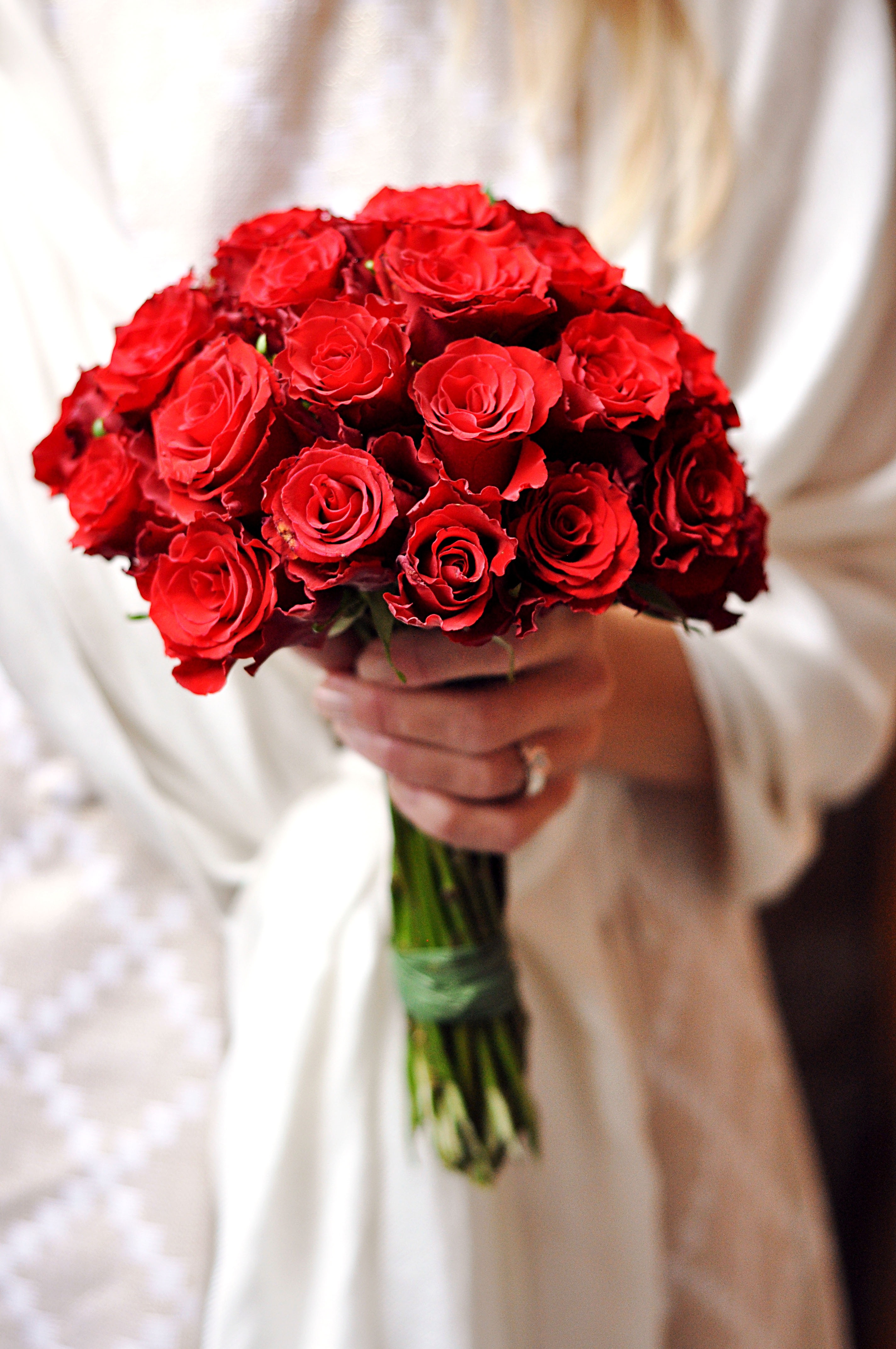 woman holding a red rose bouquet