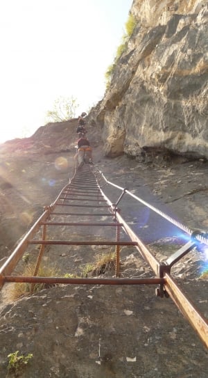 people climbing on brown steel ladder on grey rock mountain during dyatume thumbnail