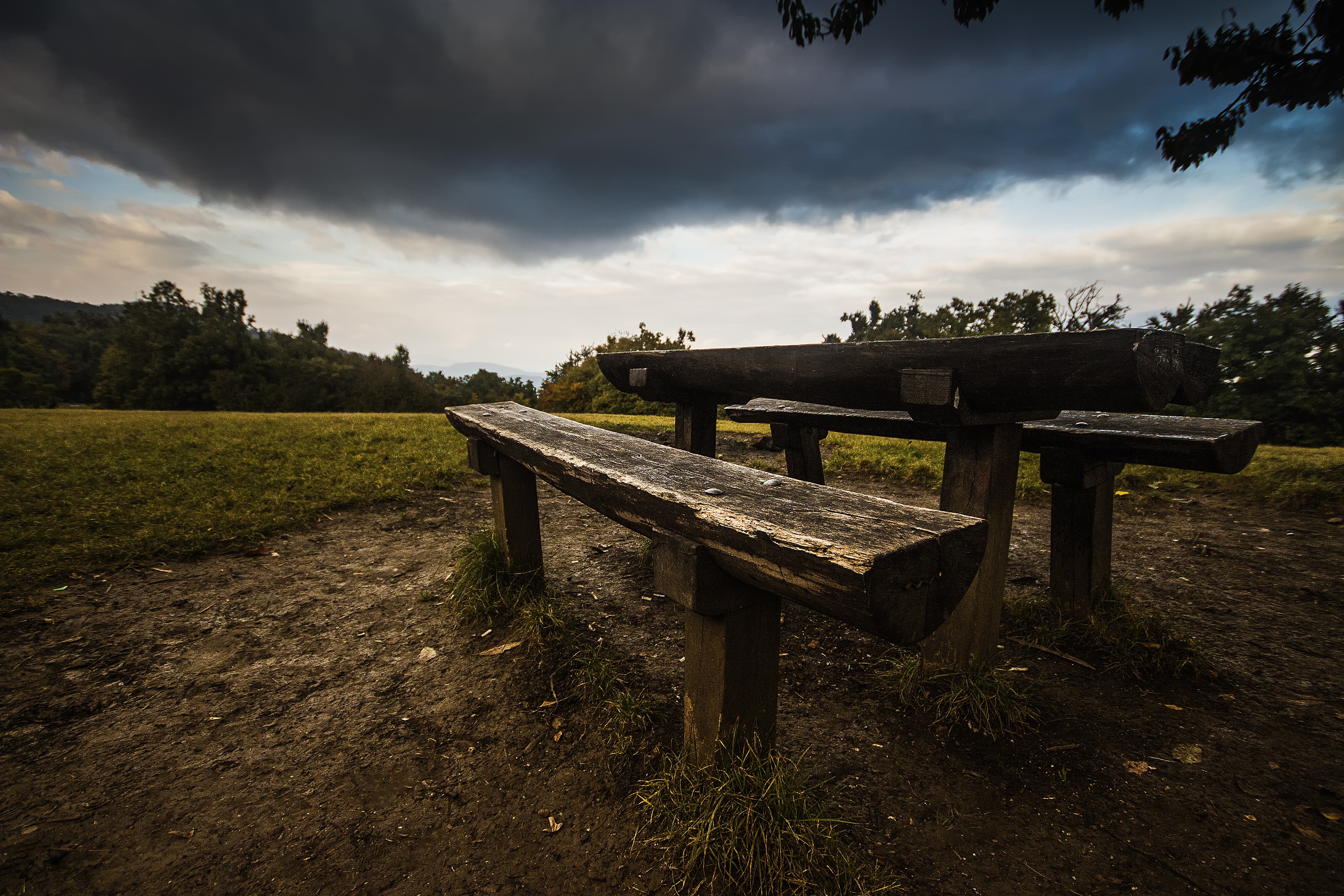 brown wooden picnic table near green grass field