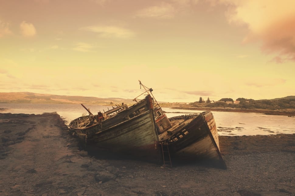 sephia photography of two wooden boats on gray sand preview
