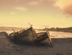 sephia photography of two wooden boats on gray sand thumbnail