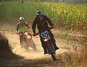 men's black red motorcycle jacket and white motocross helmet and red white dirt bike thumbnail