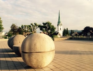 four beige concrete oval shape statues thumbnail