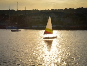 white and yellow sail boat thumbnail