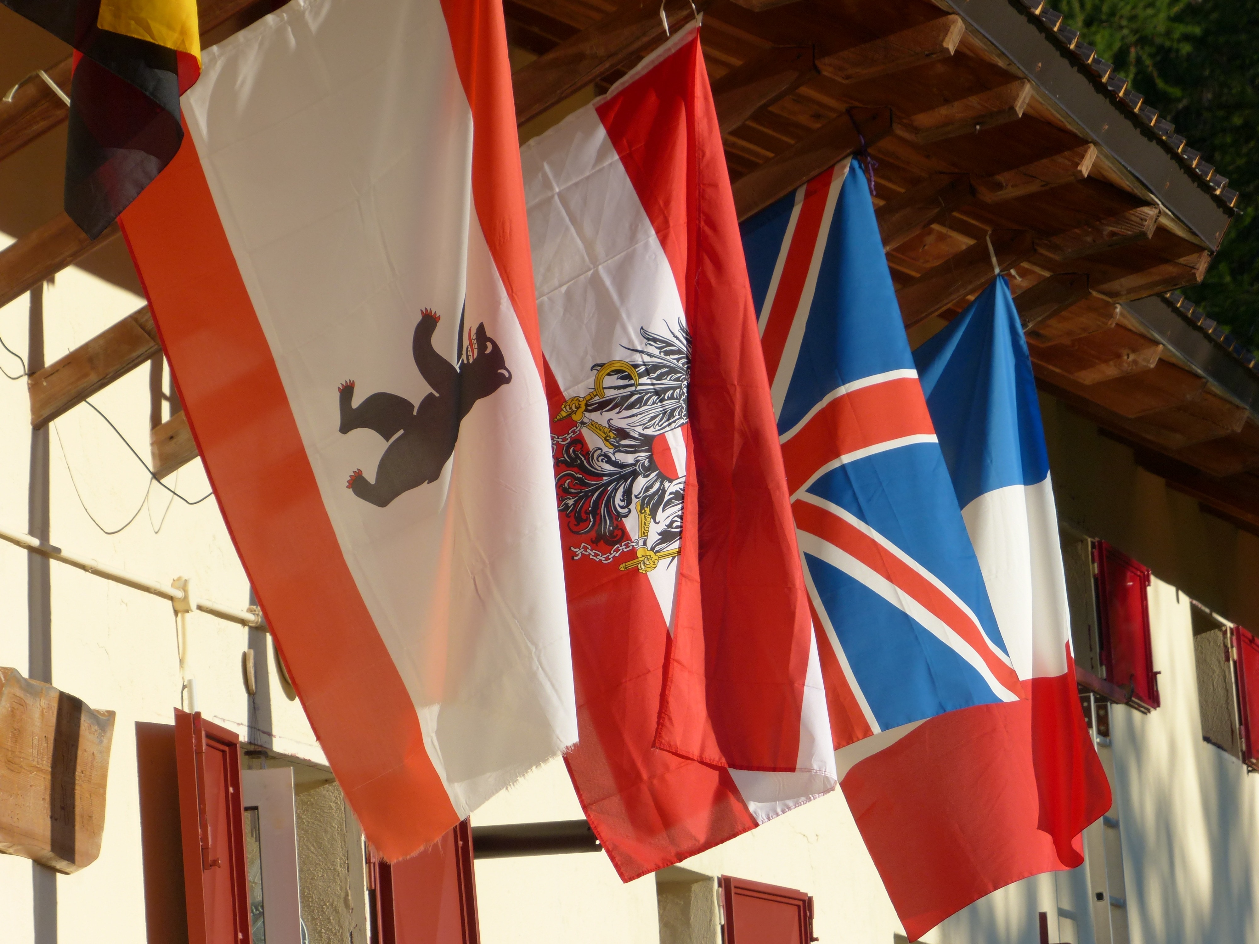 four assorted country flags