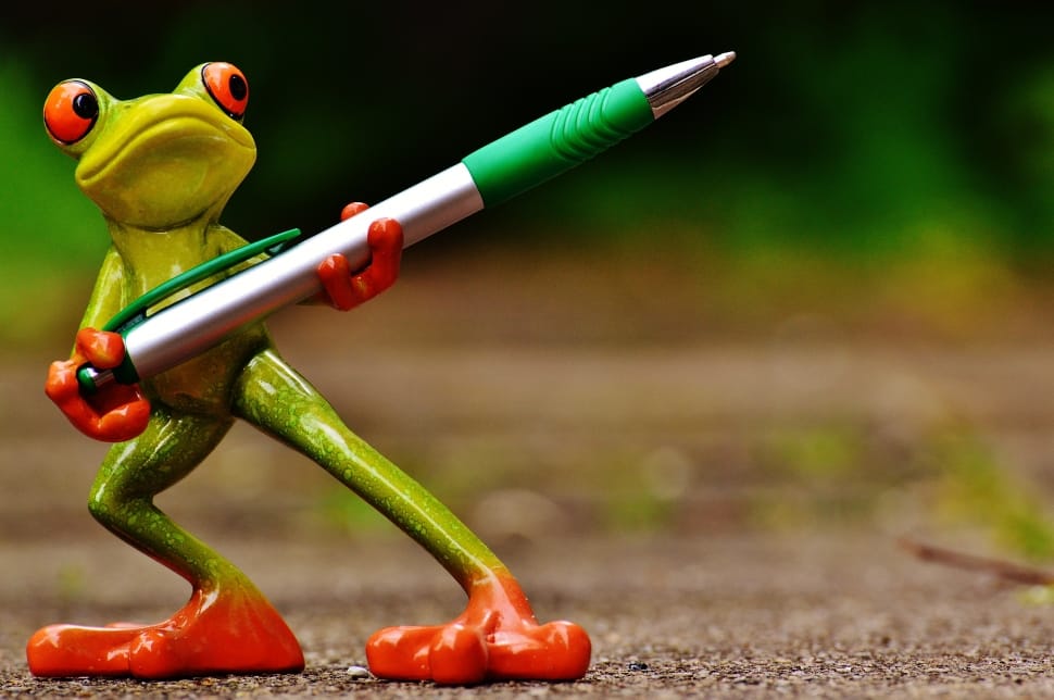 orange and green frog carrying click pen figurine preview
