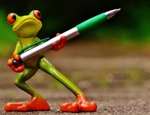orange and green frog carrying click pen figurine thumbnail