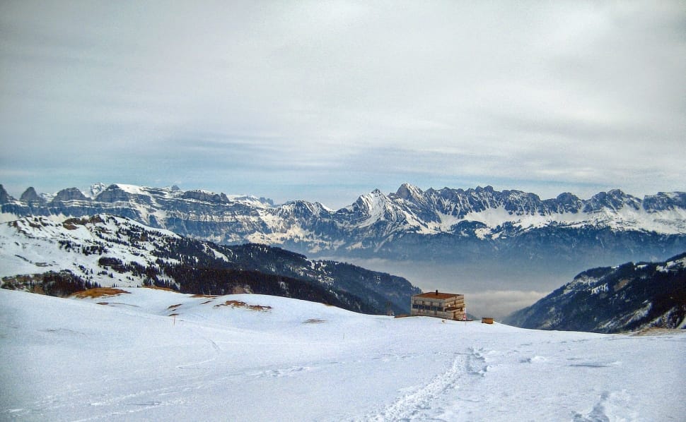 snowfield with brown wooden house at distance preview