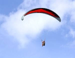 person paragliding during daytime thumbnail