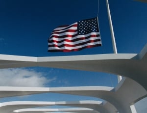 u.s.a. flag hanging on pole during daytime thumbnail