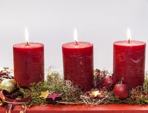 close-up photo of three red pilar candles thumbnail