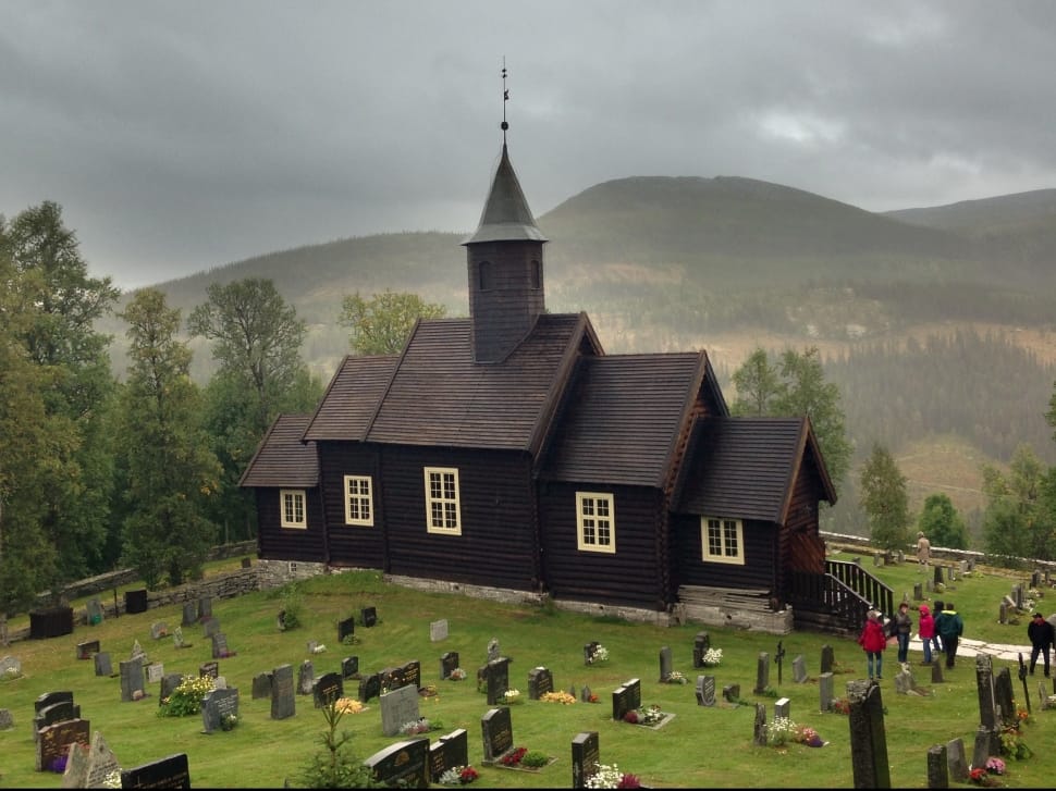 black church in middle of cemetery during cloudy daytime preview