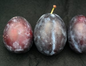 3 red and black round fruits thumbnail
