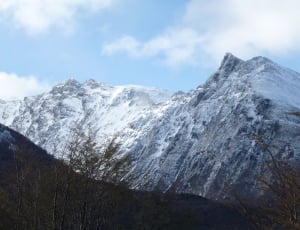 snow covered mountain under cloudy sky during daytime thumbnail