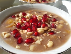 close capture of a swetened dessert soup with red cherries thumbnail