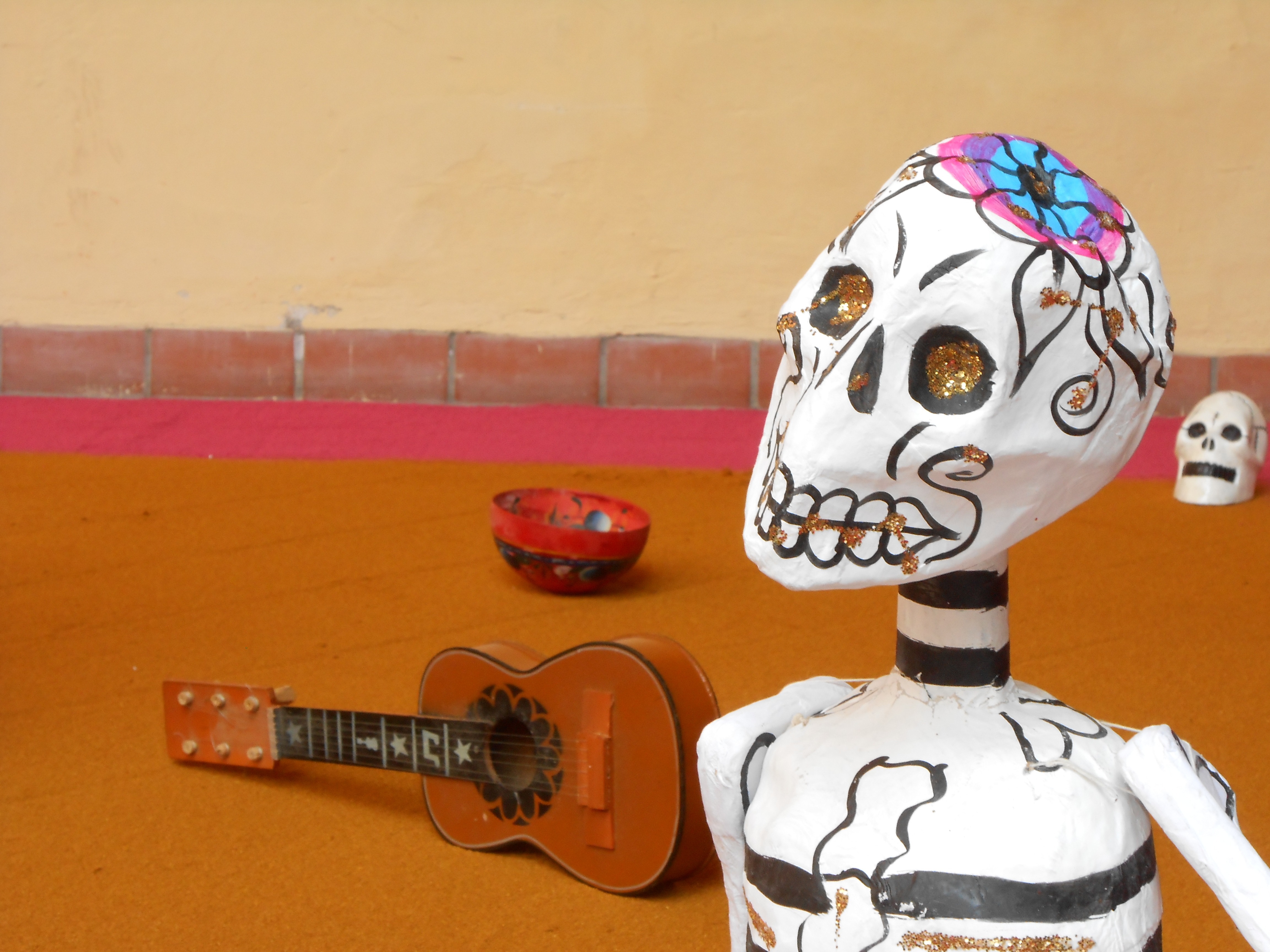 white calabera figurine and ukulele