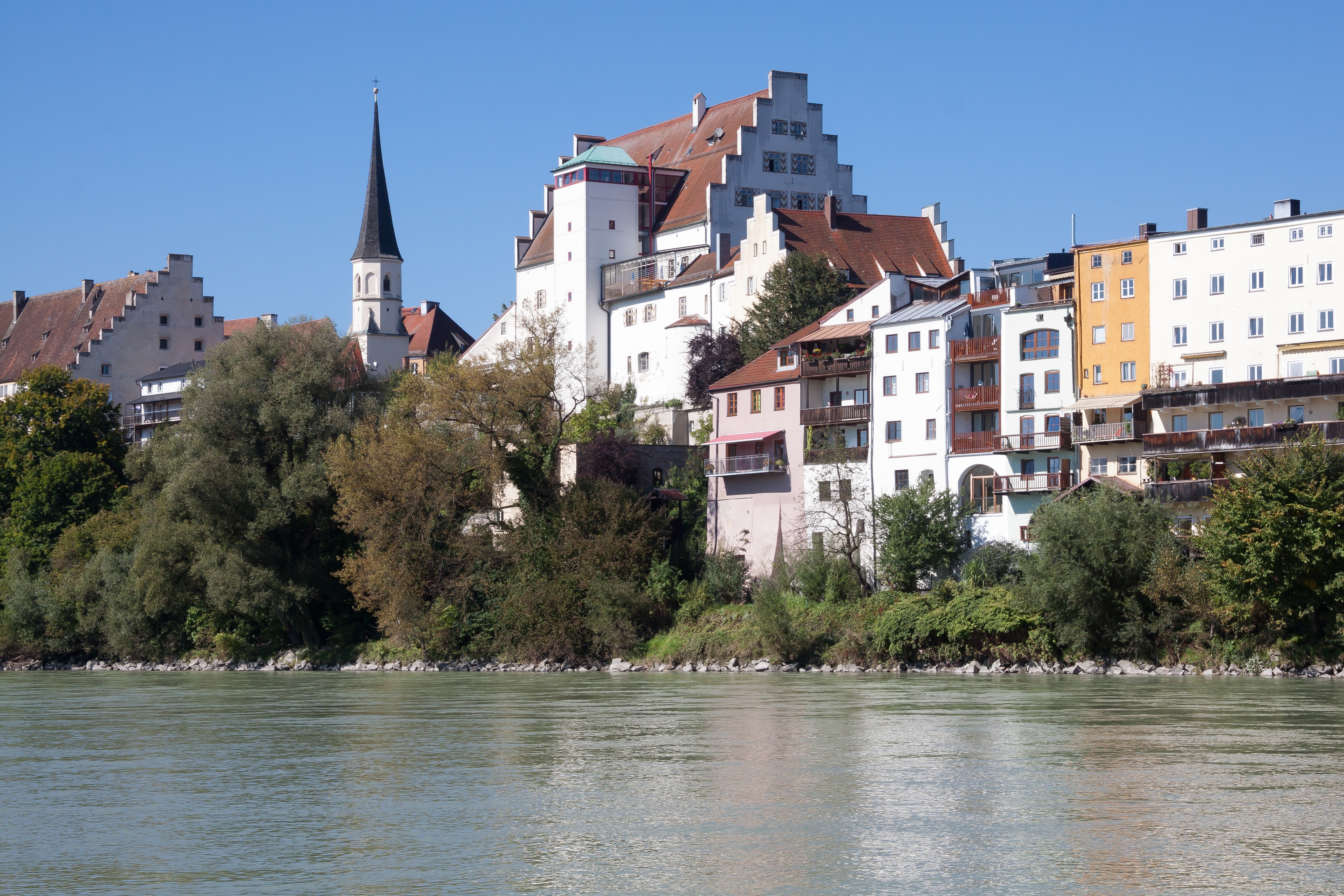 white brown yellow concrete building near river