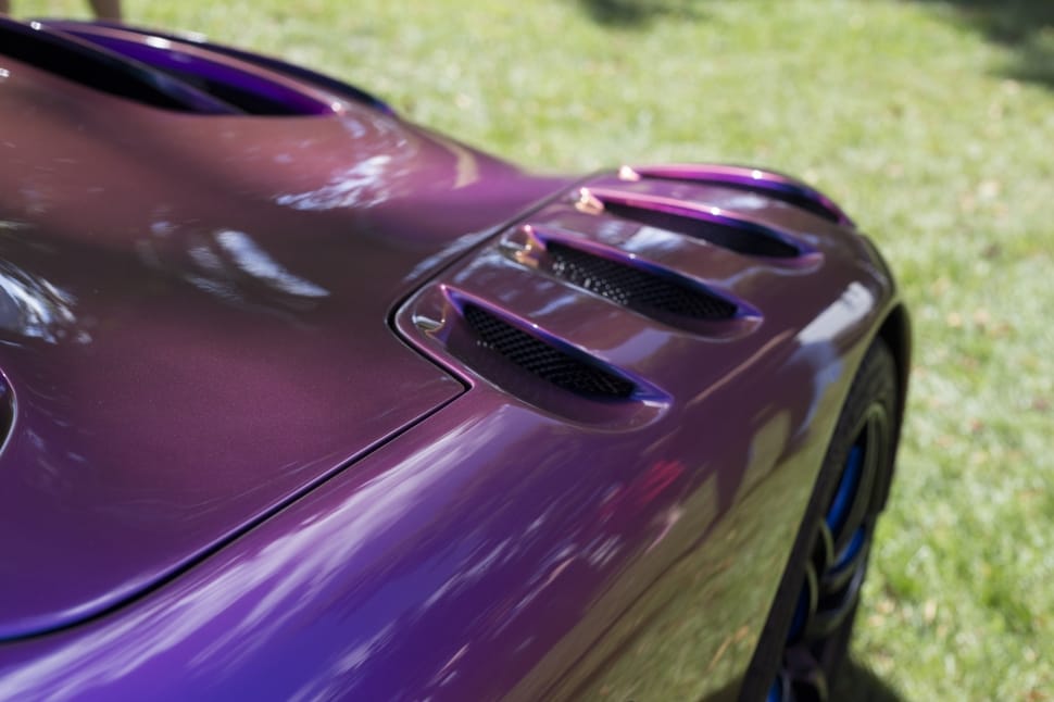 purple luxury car on green grass field preview