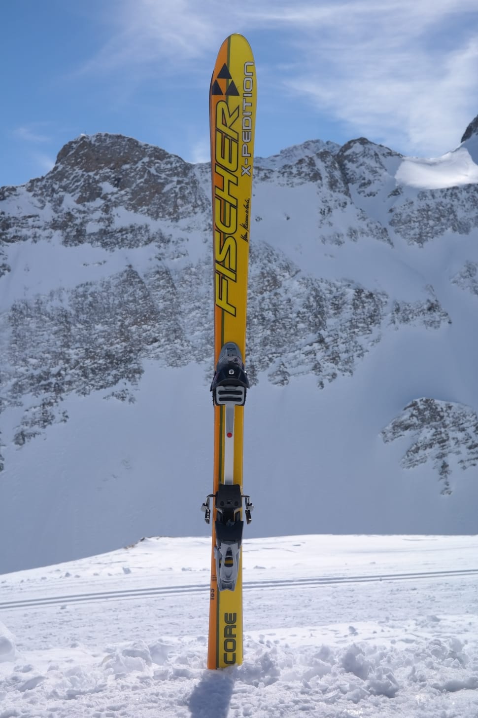 yellow Fischer core ski on the snow coated mountain at daytime preview