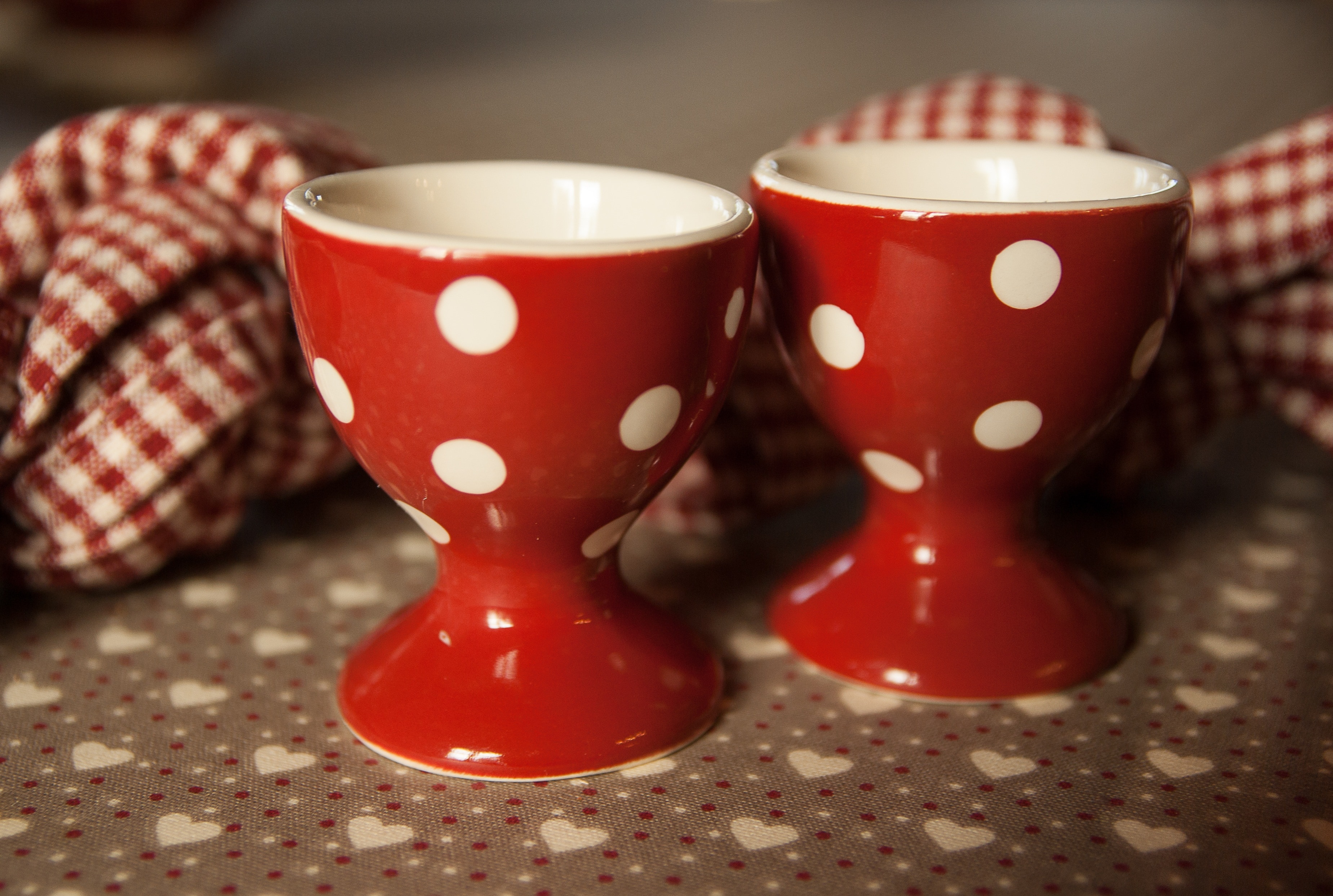 two red and white polka dot ceramic cup